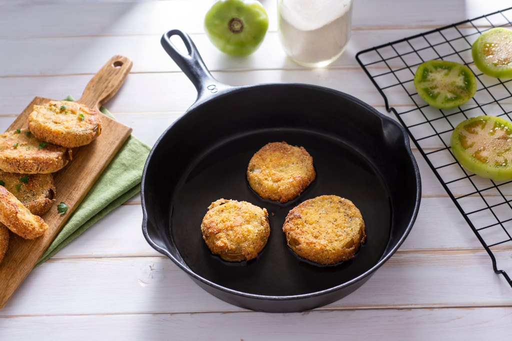 Fried green tomatoes in a cast iron skillet