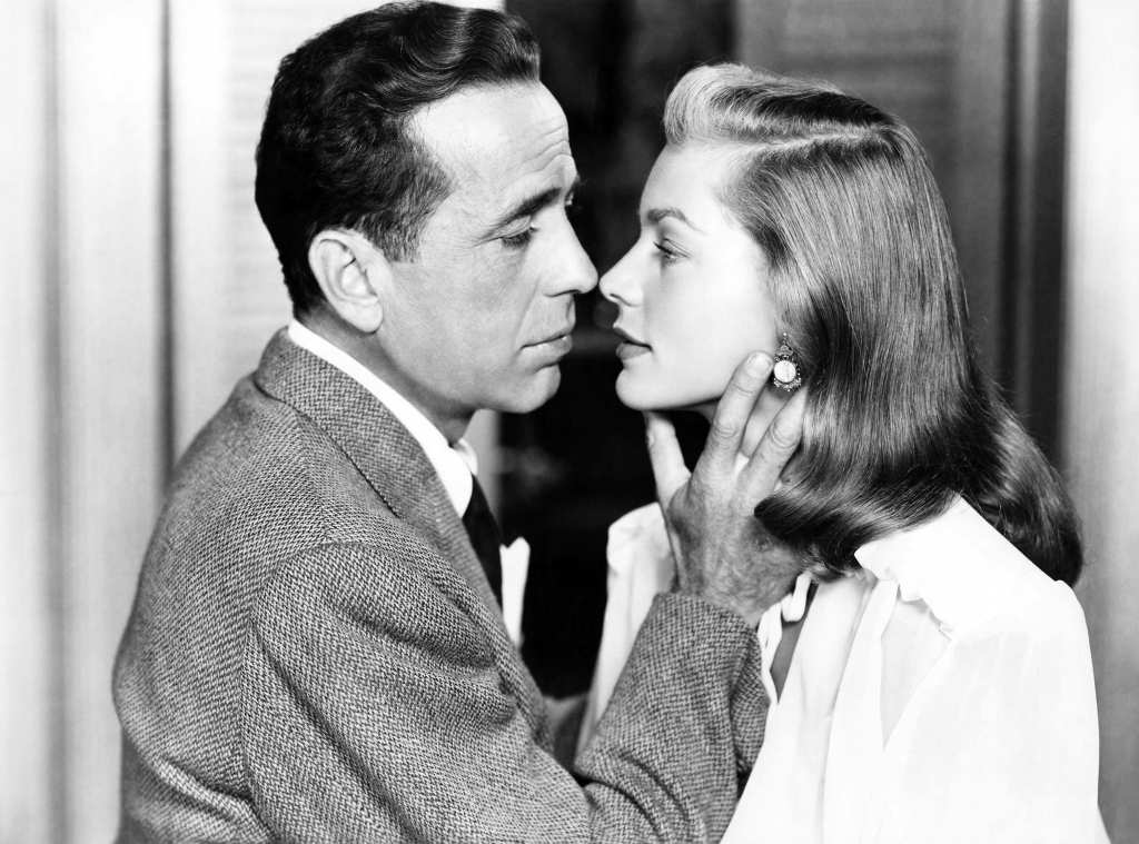 man holding woman's chin; old hollywood couples