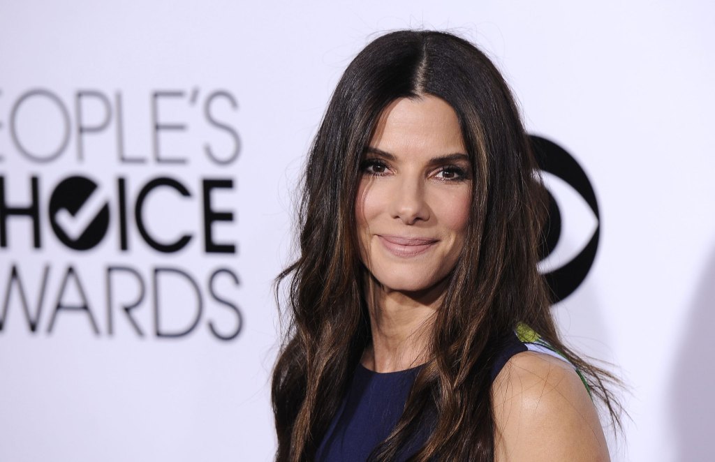 woman smiling; celebrities first jobs