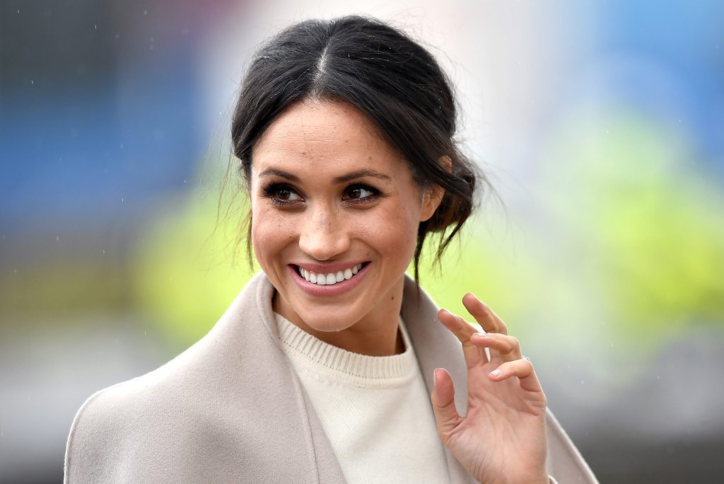 woman smiling and waving