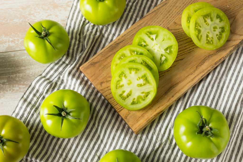 Raw green tomatoes as part of a recipe guide for fried green tomatoes