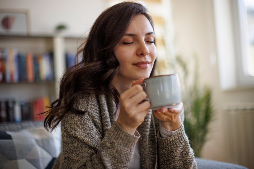 woman drinking cup of coffee