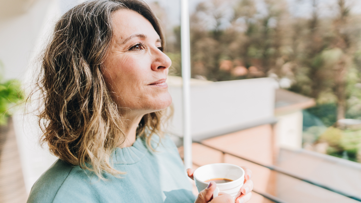 woman outside with cup of coffee
