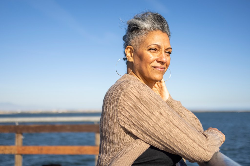 woman relaxes on the pier at the beach