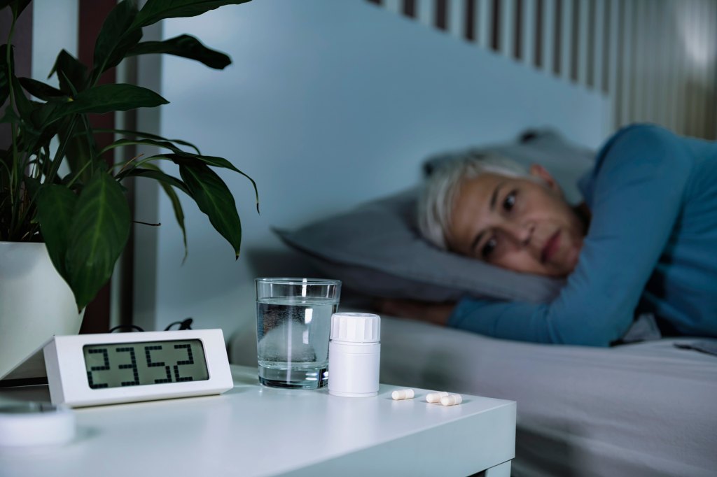 mature woman experiencing irregular sleep at night in bed, which can raise her diabetes risk