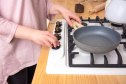 mature woman using a Teflon nonstick pan for cooking, which is safe when used properly
