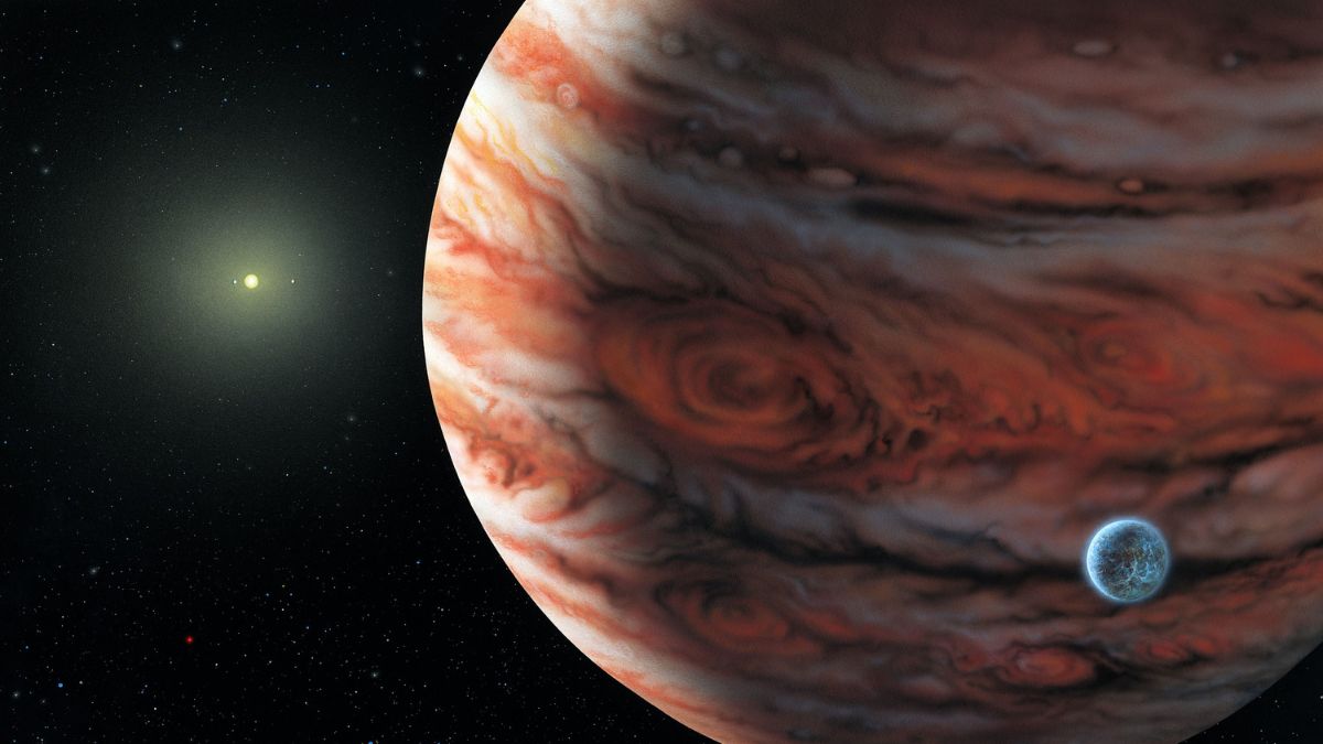 This artist's conceptual drawing released June 13, 2002 depicts a Jupiter-mass planet orbiting the star, 55 Cancri, about 41 light years from Earth. A possible moon around the planet is shown because such moons are thought to be common around this type of planet, but no moon has been detected.