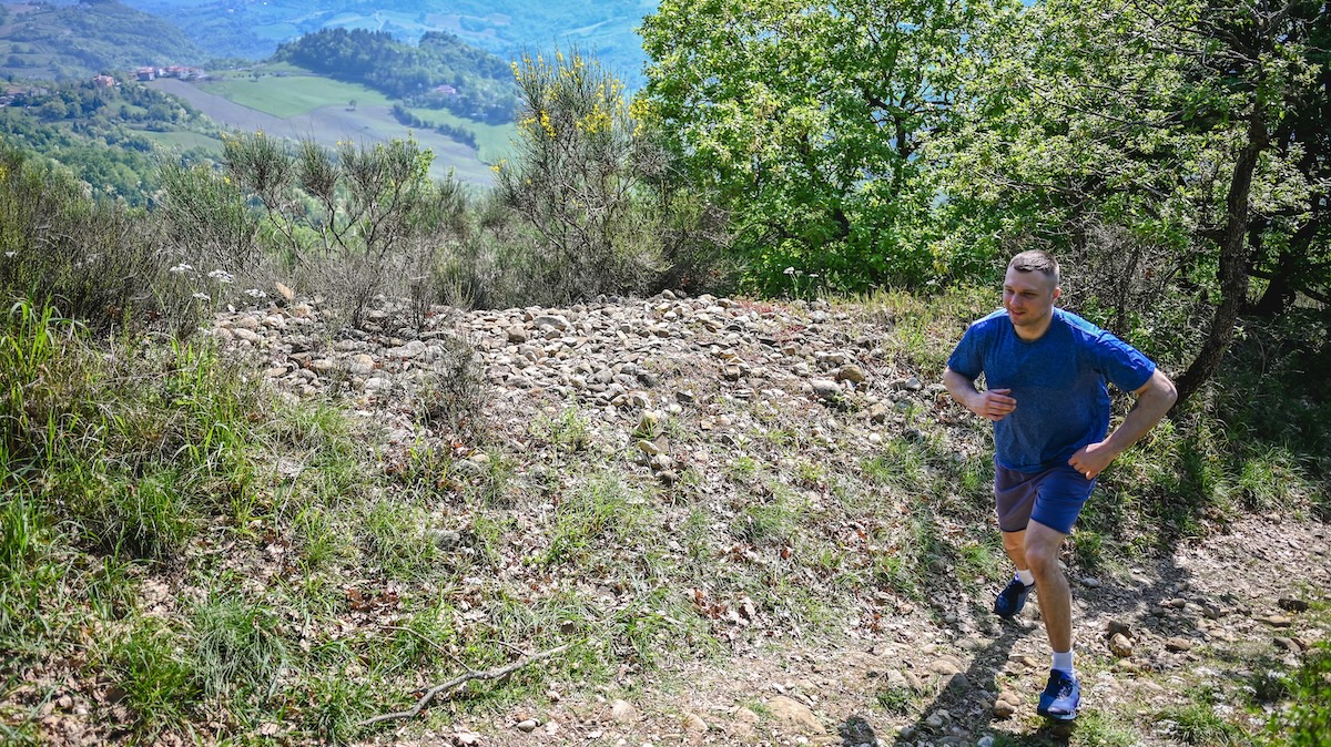 Running on a dirt road outdoors in mountains.