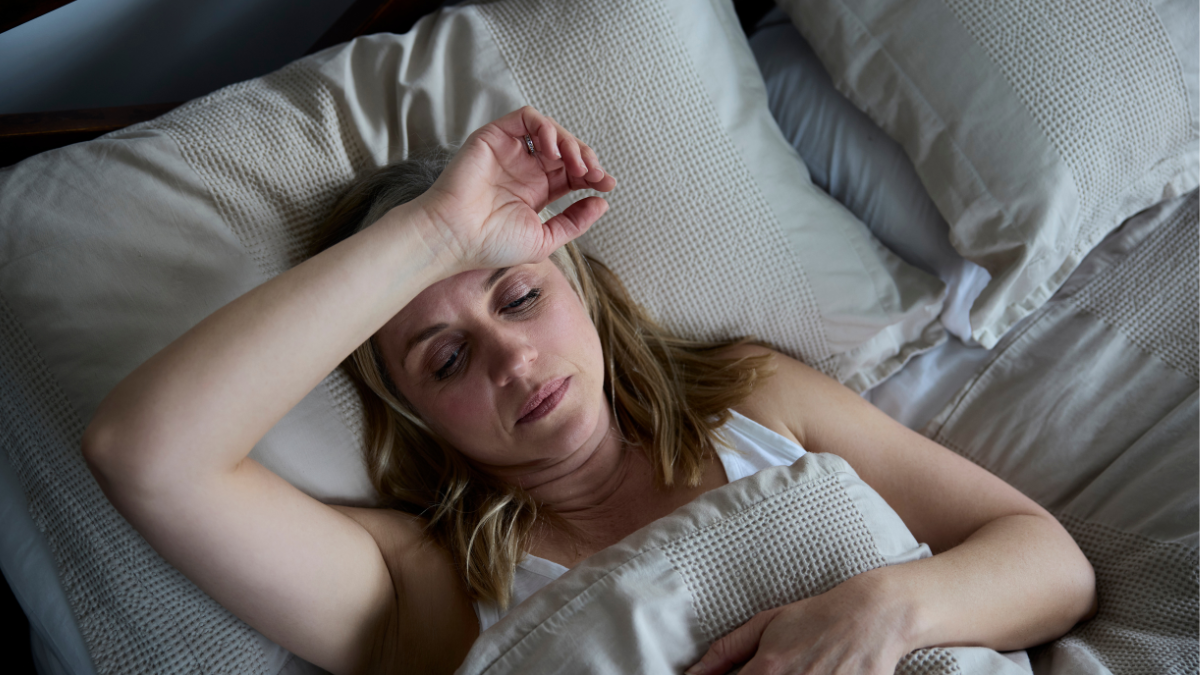 woman awake during the night with her hand on her head