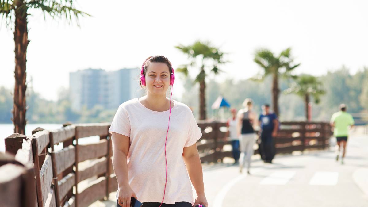 Woman walking with headphones on