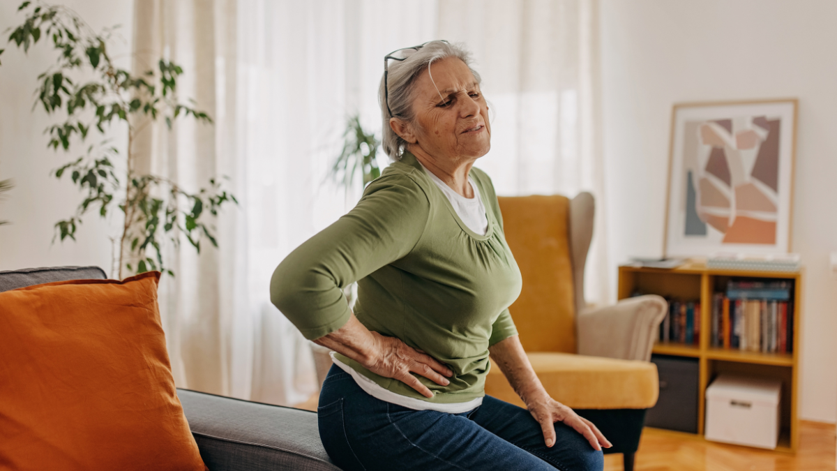 woman holding the side of her abdomen in pain