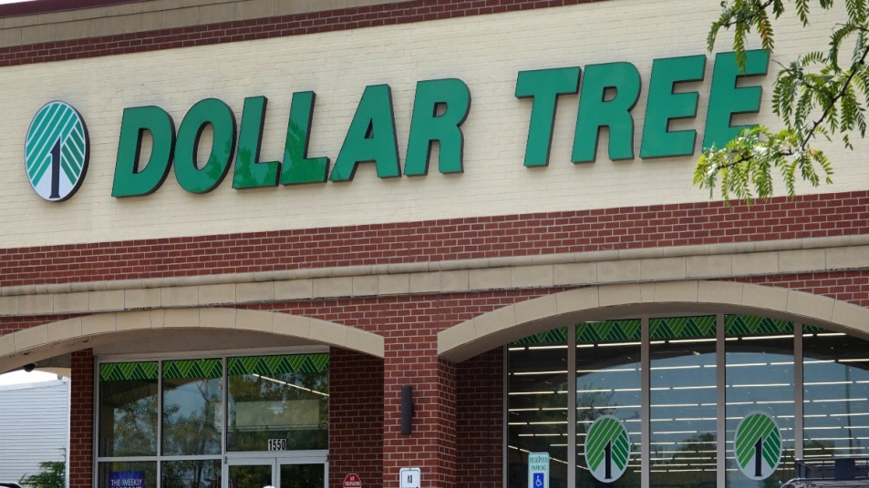 The outside of a Dollar Tree Store shines in the sun with trees around waiting for people to come in after learning how to save money at dollar tree.