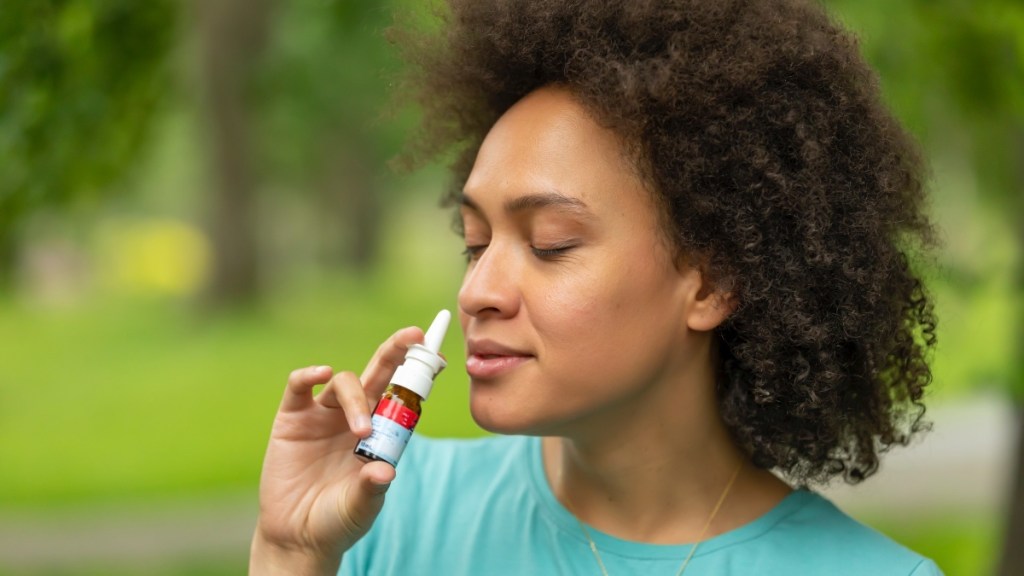 Woman using a nasal spray for an aging voice