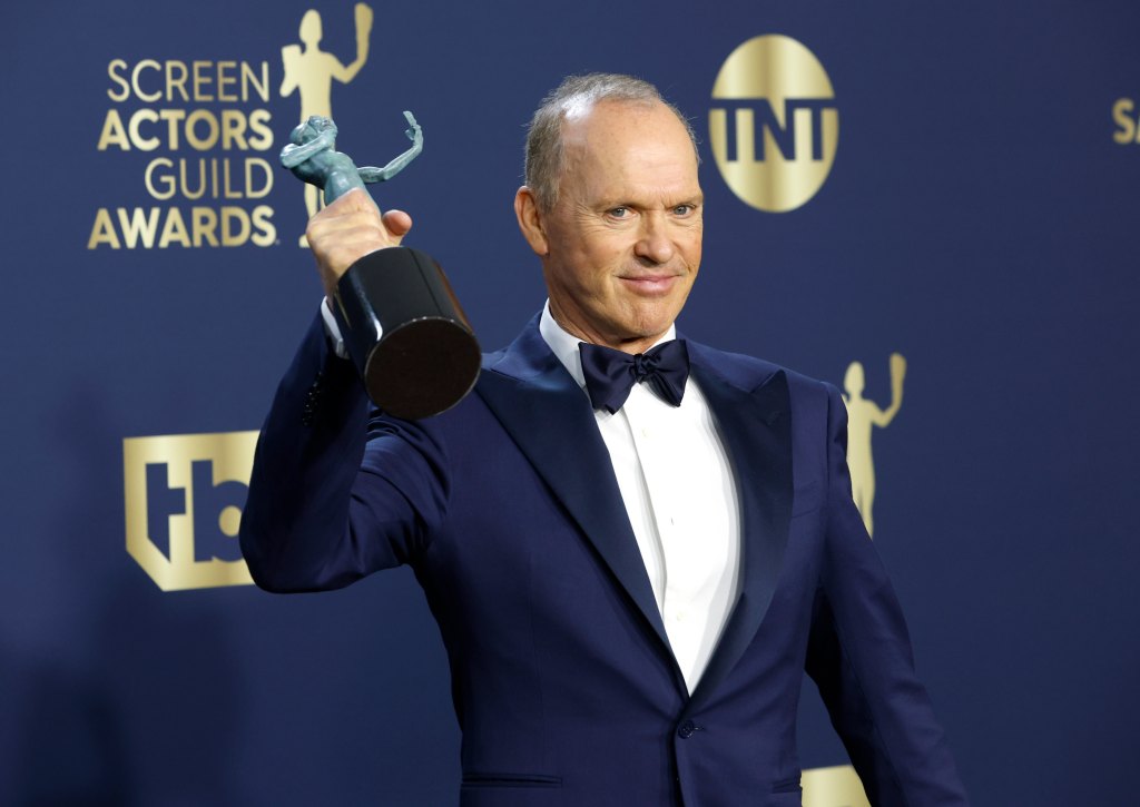 man holding up an award