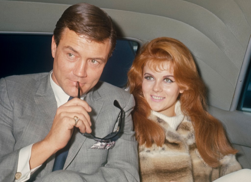 Roger Smith with sun glasses and Ann-Margret in the back of a limo; circa 1970; New York