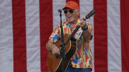 Jimmy Buffett onstage with guitar