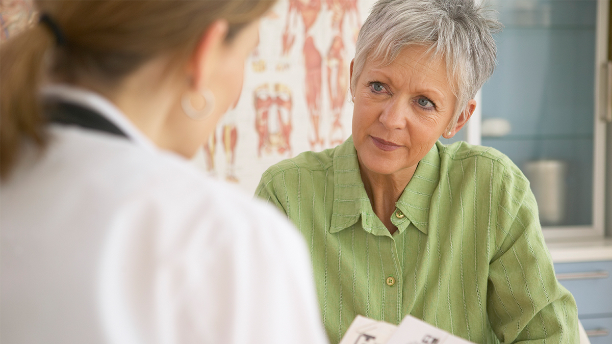 Elderly woman talking to her doctor