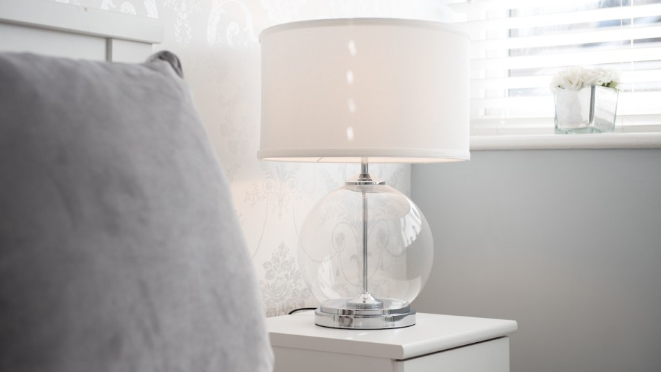 Lamp with white lampshade in bedroom