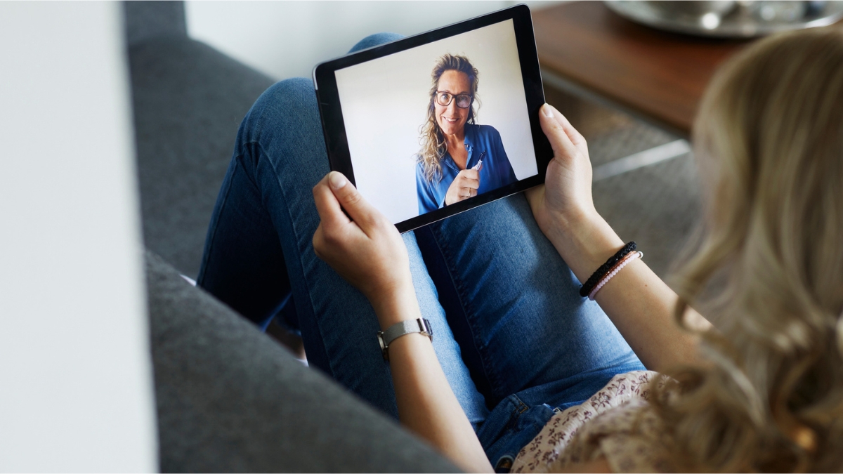 woman using her tablet to speak to her doctor about her health concerns via telehealth consolutation
