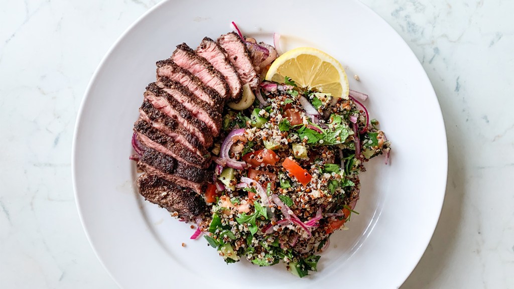 A steak seasoned with Texas Roadhouse steak seasoning and served with quinoa salad