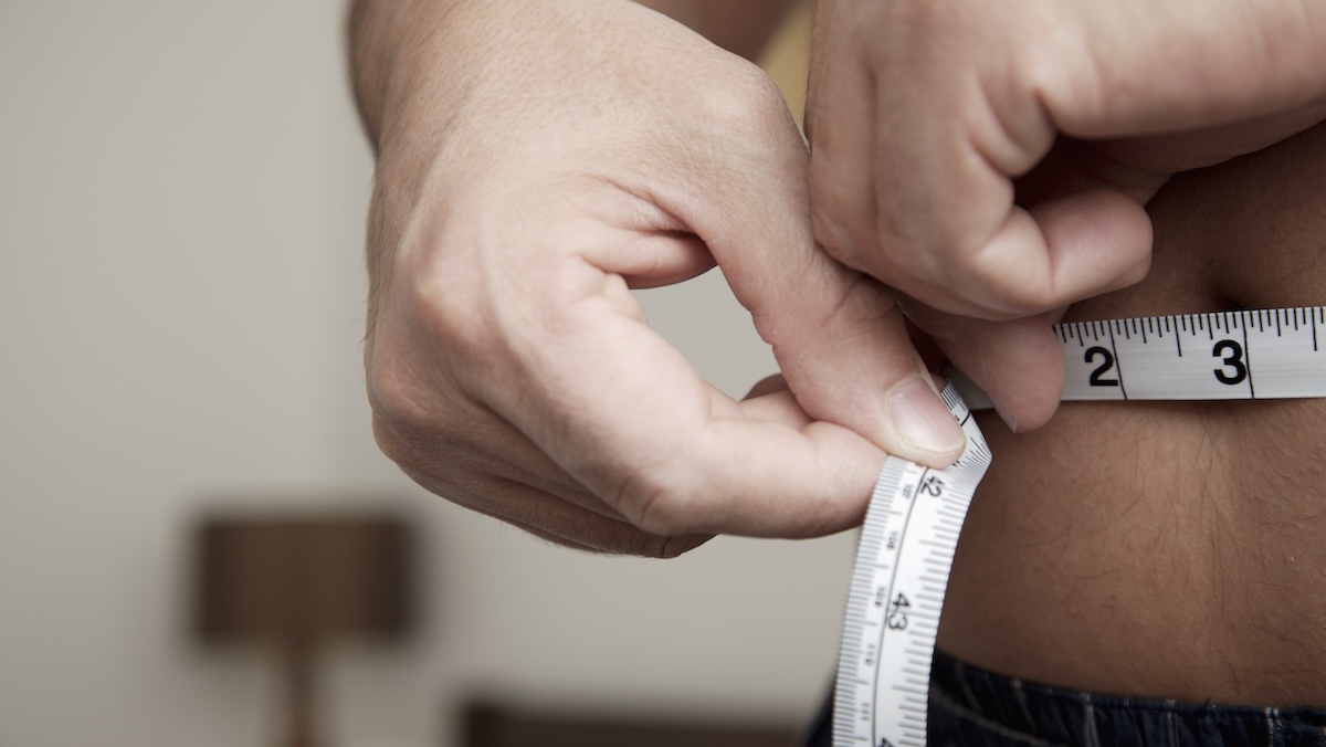 Man tracking his weight loss based on waist circumference.