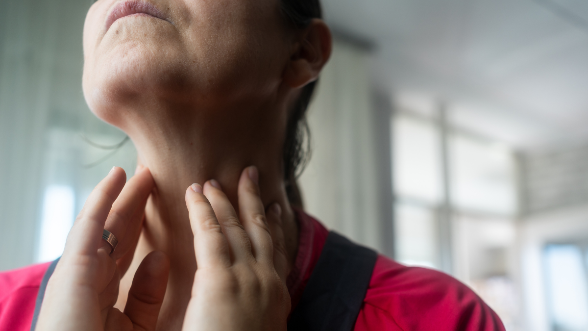 closeup of woman holding neck