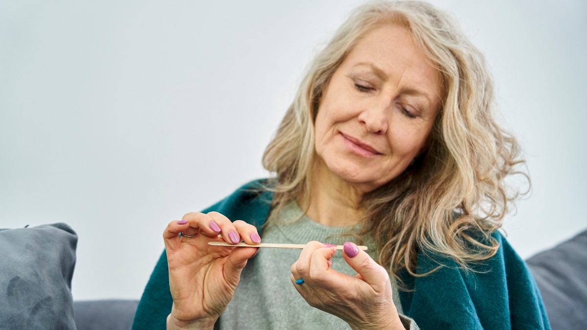 mature woman filing nails