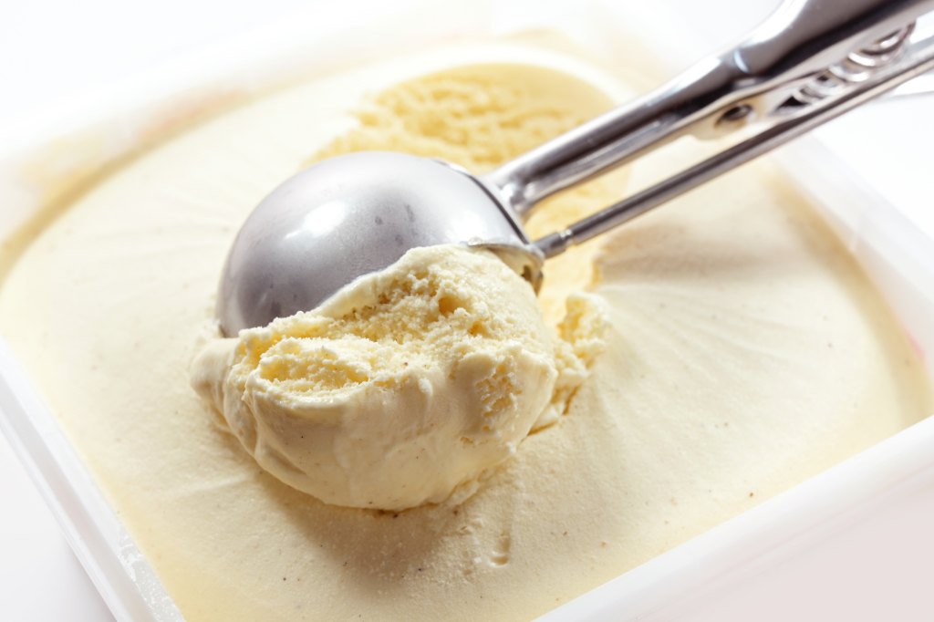 scoop of vanilla ice cream from tub