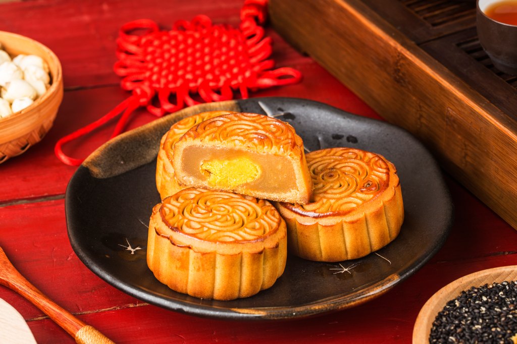 Traditional mooncake recipes with salted egg yolk and bean paste filling on plate