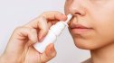 Woman using nasal spray