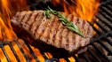Cooked steak on the grill seasoned with a copycat recipe of Texas Roadhouse steak seasoning