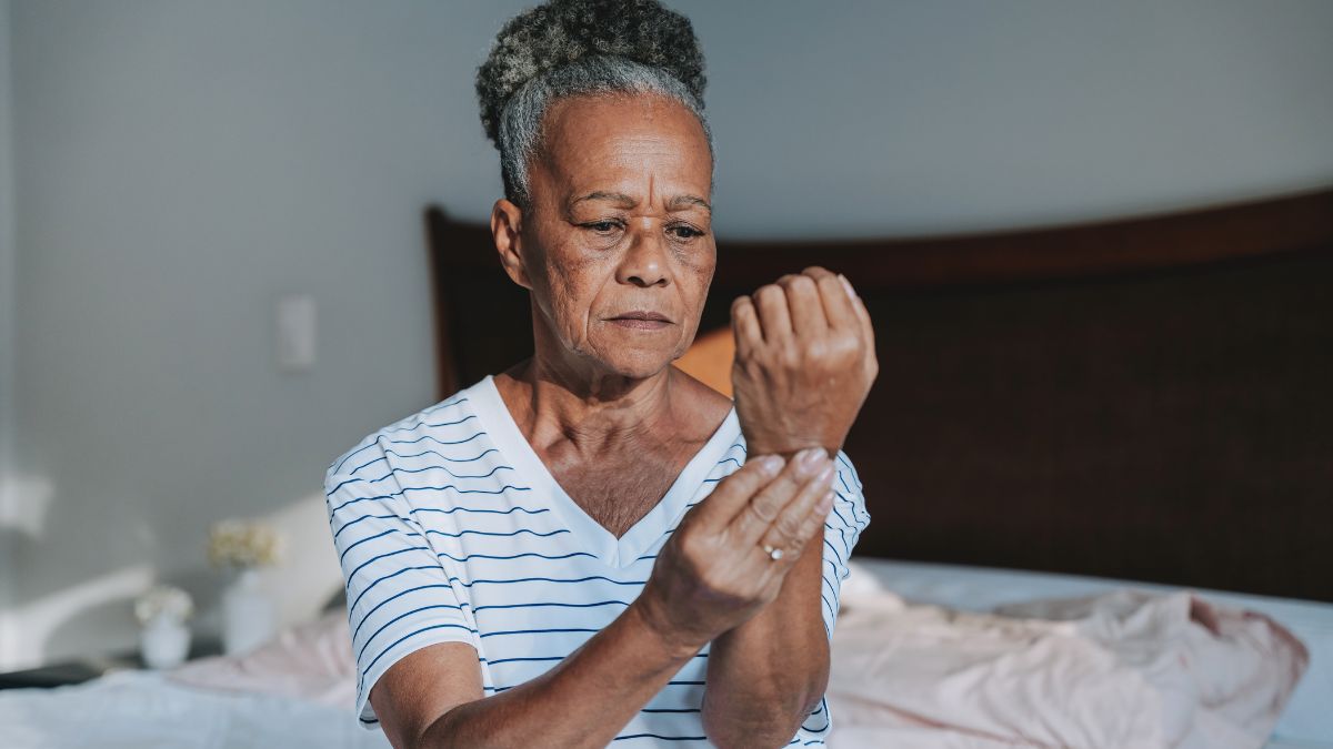woman holding her wrist in pain, considering ulnar wrist pain treatment