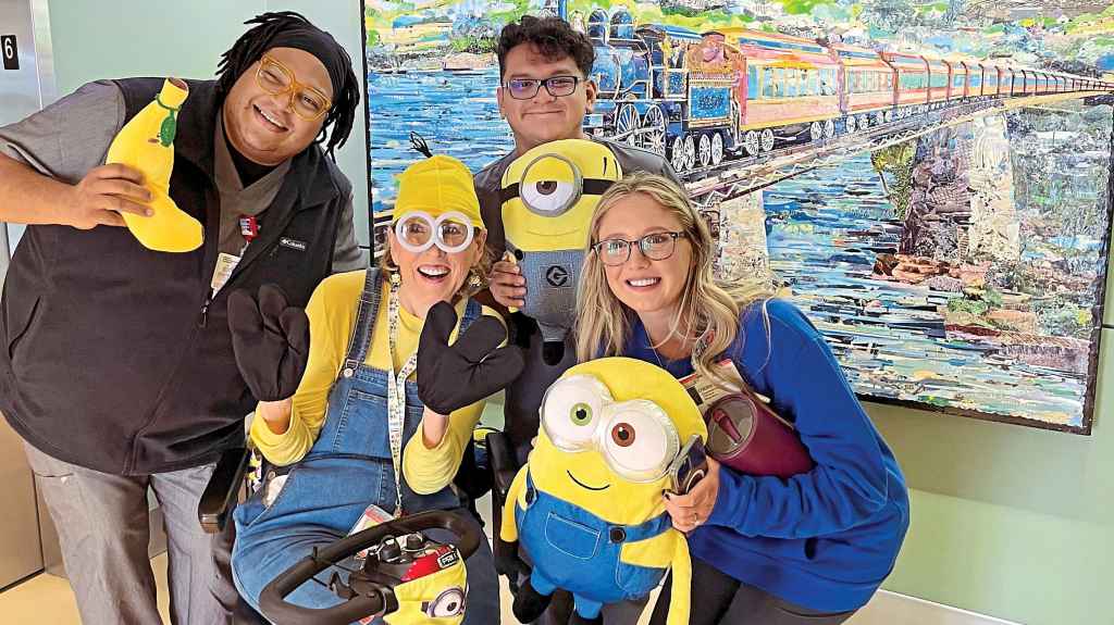 Malia (second from left) dresses up in fun costumes to brighten the days of young patients and staff at a Dallas children’s hospital