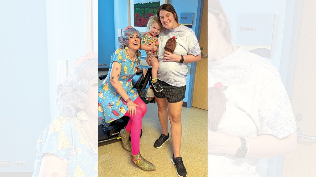 Malia (left) in her ice-cream cone outfit visits with a patient and her mom. It is one of over 50 costumes she dons