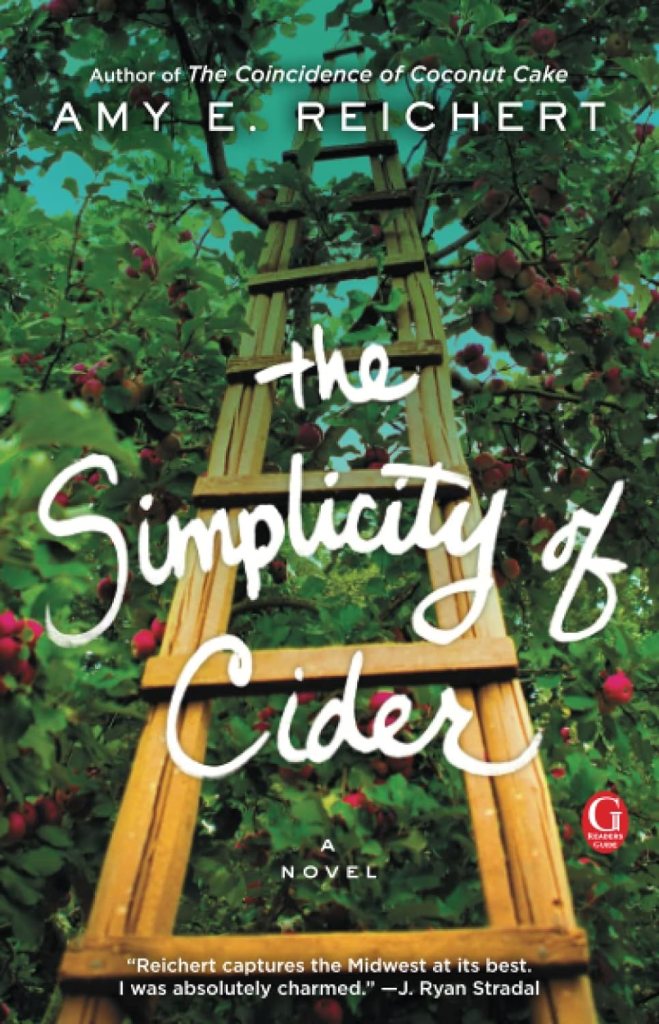 Cozy Fall Reads: The Simplicity of Cider by Amy E. Reichert book cover shows a ladder in an apple orchard with trees and apples surrounding it