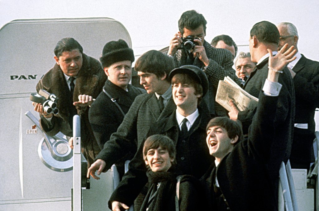 The Beatles arrive at Kennedy Airport for the first time from London for a 10-day tour on February 7, 1964 in New York City, New York.