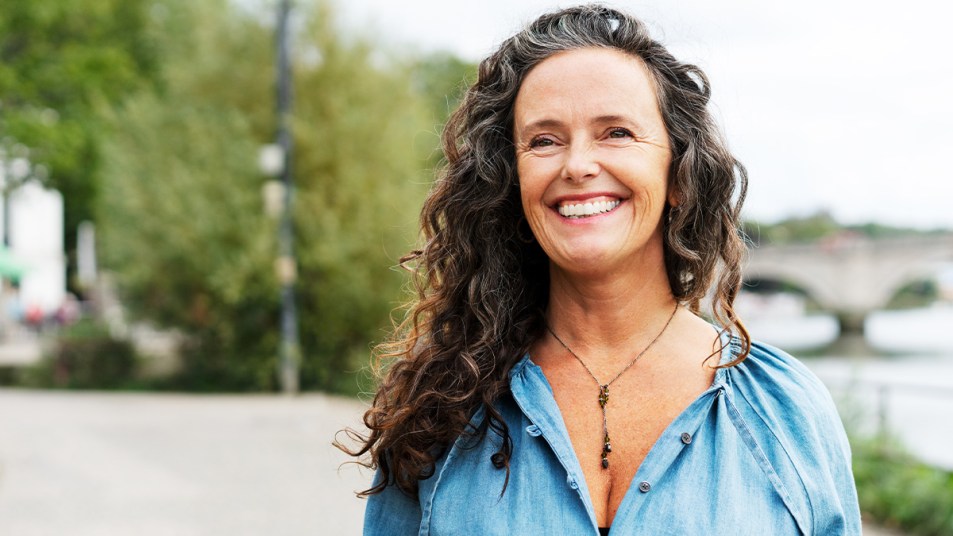 Mature woman smiling with curly hair