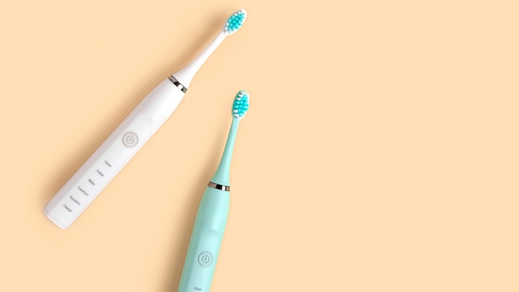 Two electric toothbrushes, one white and one mint, which can help reverse gum disease