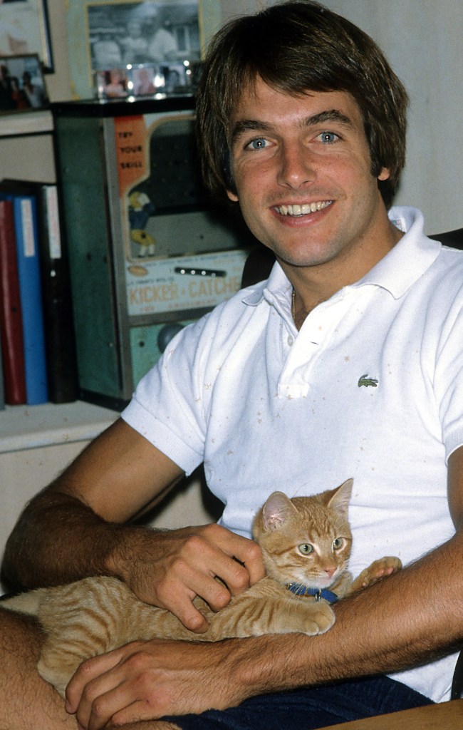 Mark Harmon with a cat in 1985