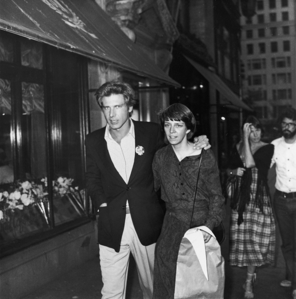 June 1977: Harrison Ford and wife, Mary Marquardt, walking in New York City. Filmmaker George Lucas and wife, Marcia, walk behind them.