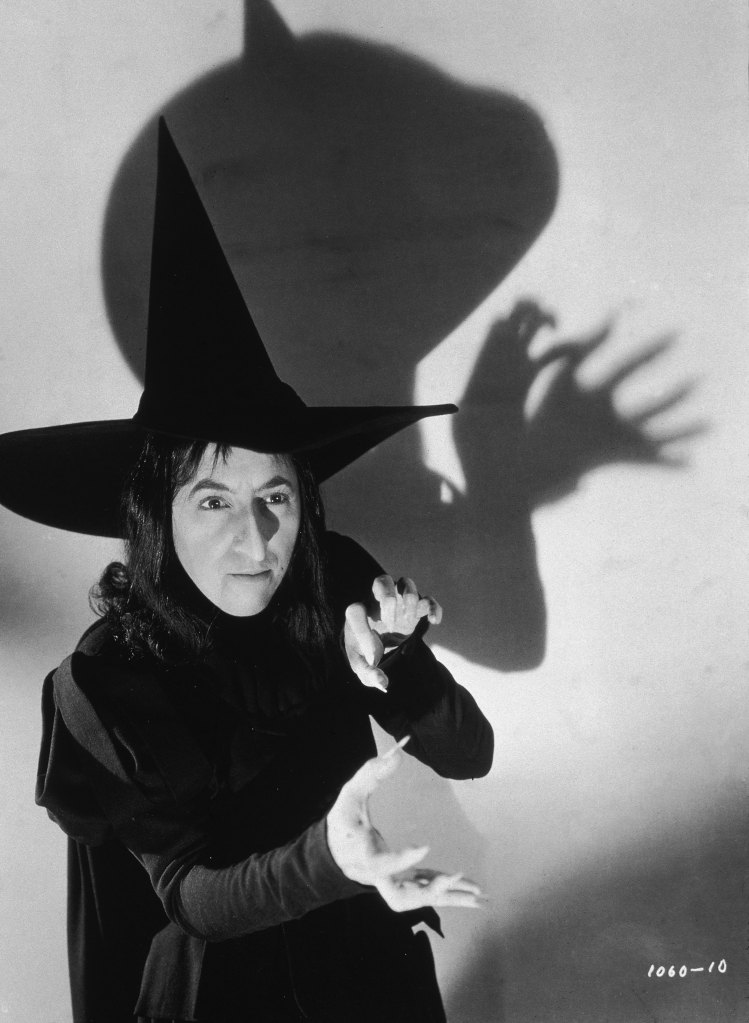 Margaret Hamilton dressed as the Wicked Witch of the West but without her full makeup.