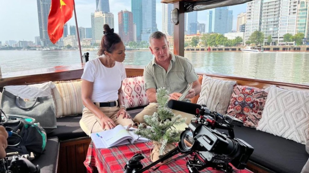 Harris on the Saigon River with military historian Brian DeToy