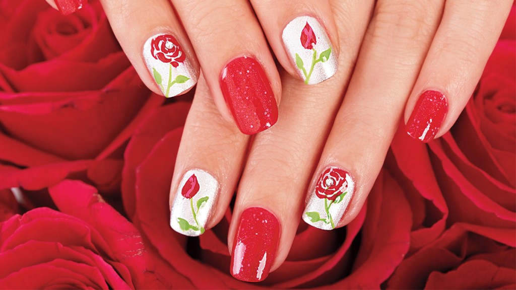 Red rose nail design on background of red roses.