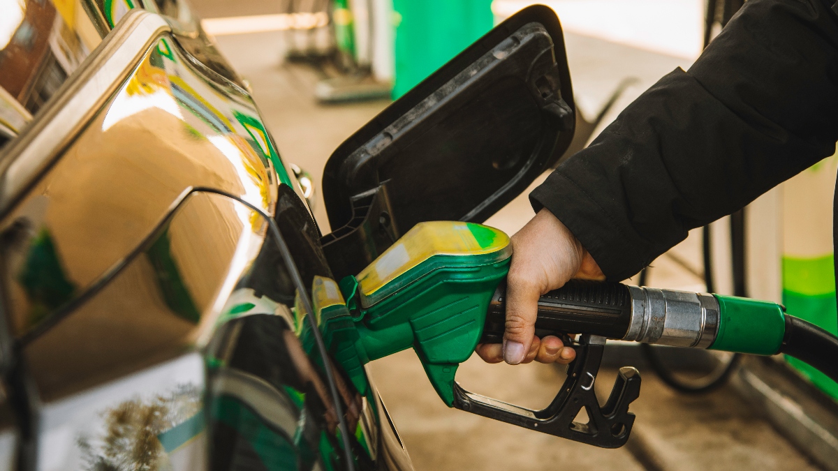A person filling up the gas tank of a car