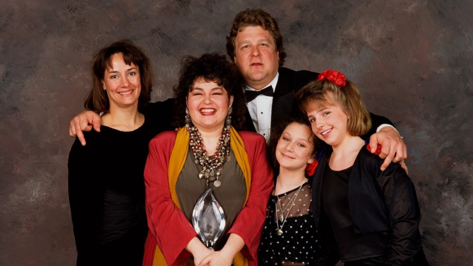 The cast of Roseanne, (l-r) Laurie Metcalf, Roseanne Barr, John Goodman, Sara Gilbert and Lecy Goranson, pose backstage after winning the 1989 People's Choice Award for best TV Comedy in Beverly Hills, California