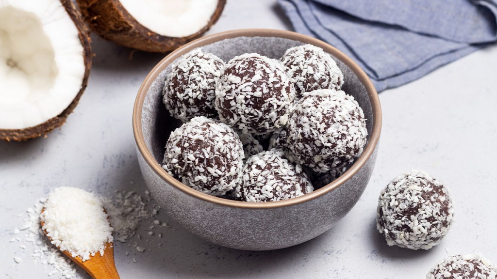 Bowl of "Happy Thyroid Pop 'Ems," which are cocoa almond butter balls rolled in shredded coconut, perfect to pair with ashwagandha for weight loss
