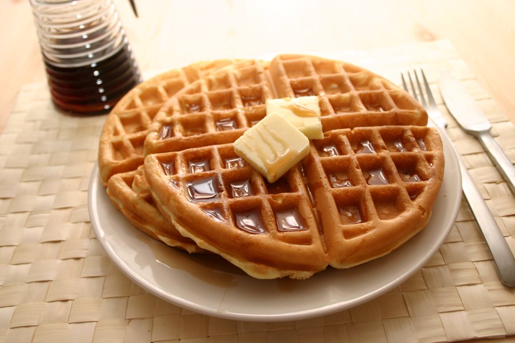 al roker's bacon waffles with butter and maple syrup on plate