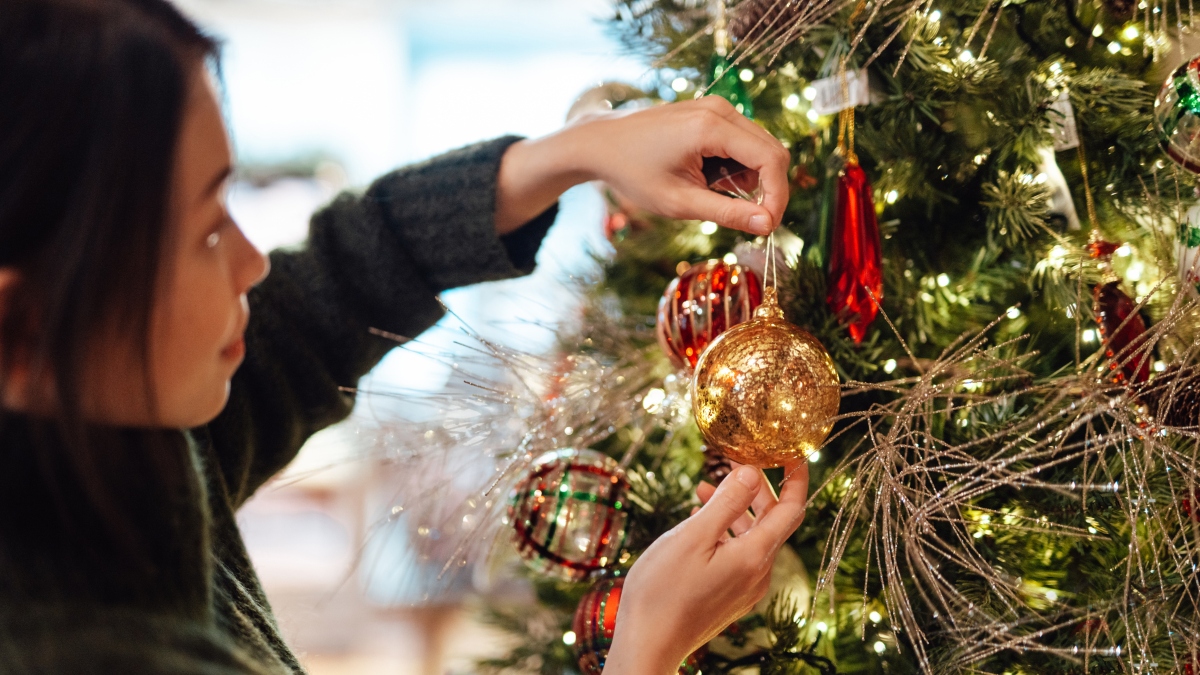 woman decorating Christmas tree