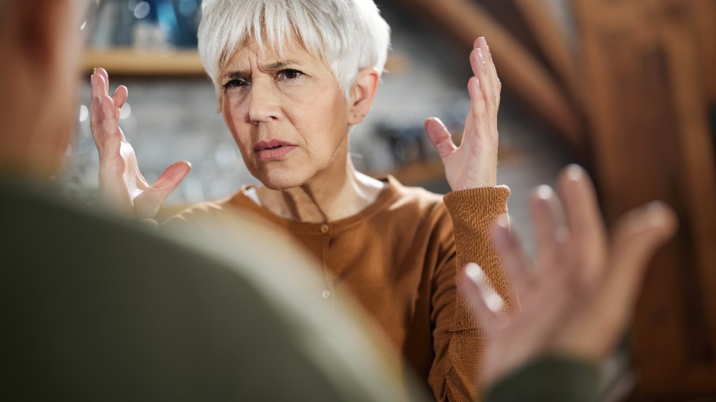 Angry senior woman arguing with a man as she stands her ground and gets in touch with healthy anger