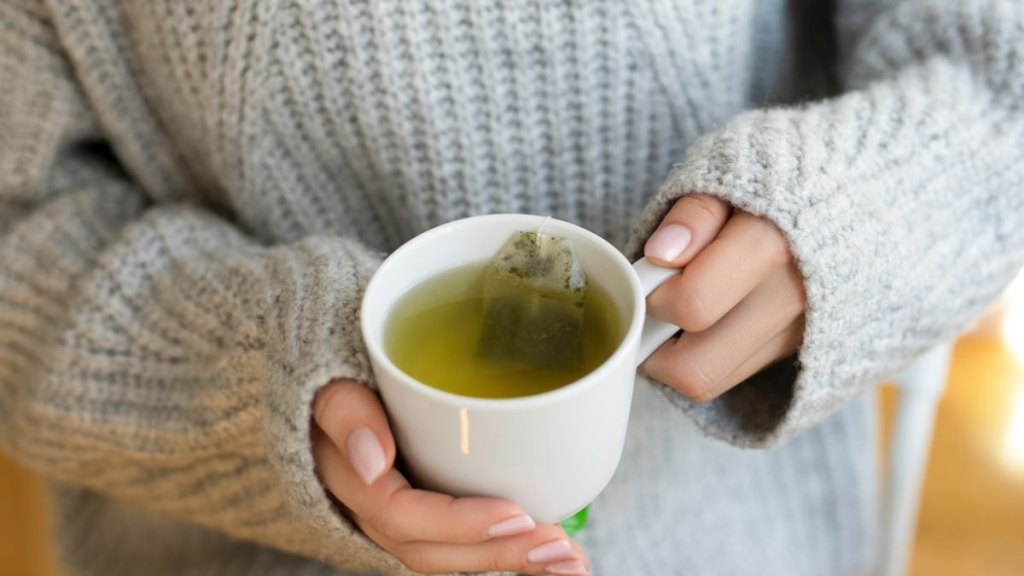 Female hands with cup of hot tea